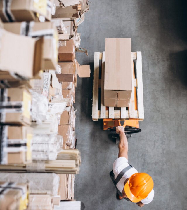 Young man working at a warehouse with boxes