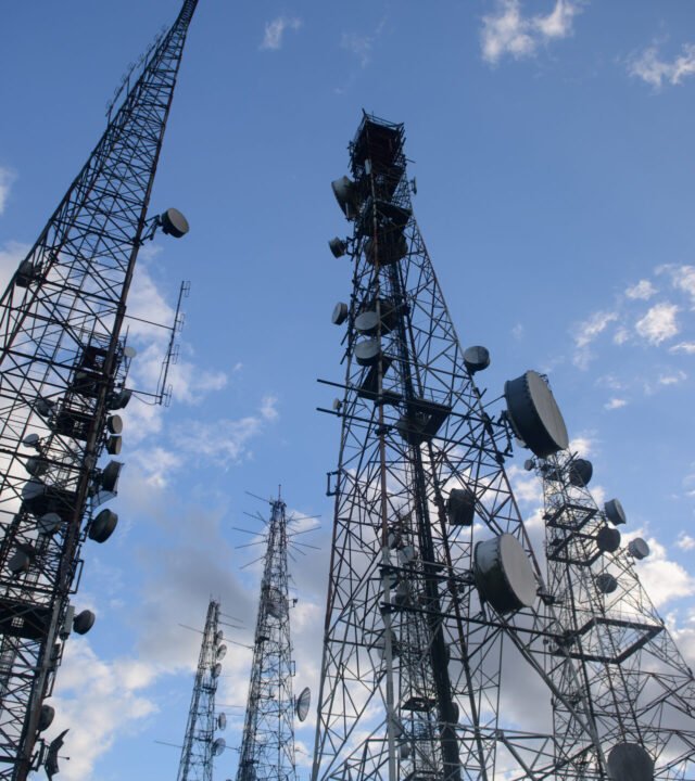 Telecommunications towers with blue skies and clouds in the background, at the Jabre peak in Matureia, Paraiba, Brazil on December 19, 2020.